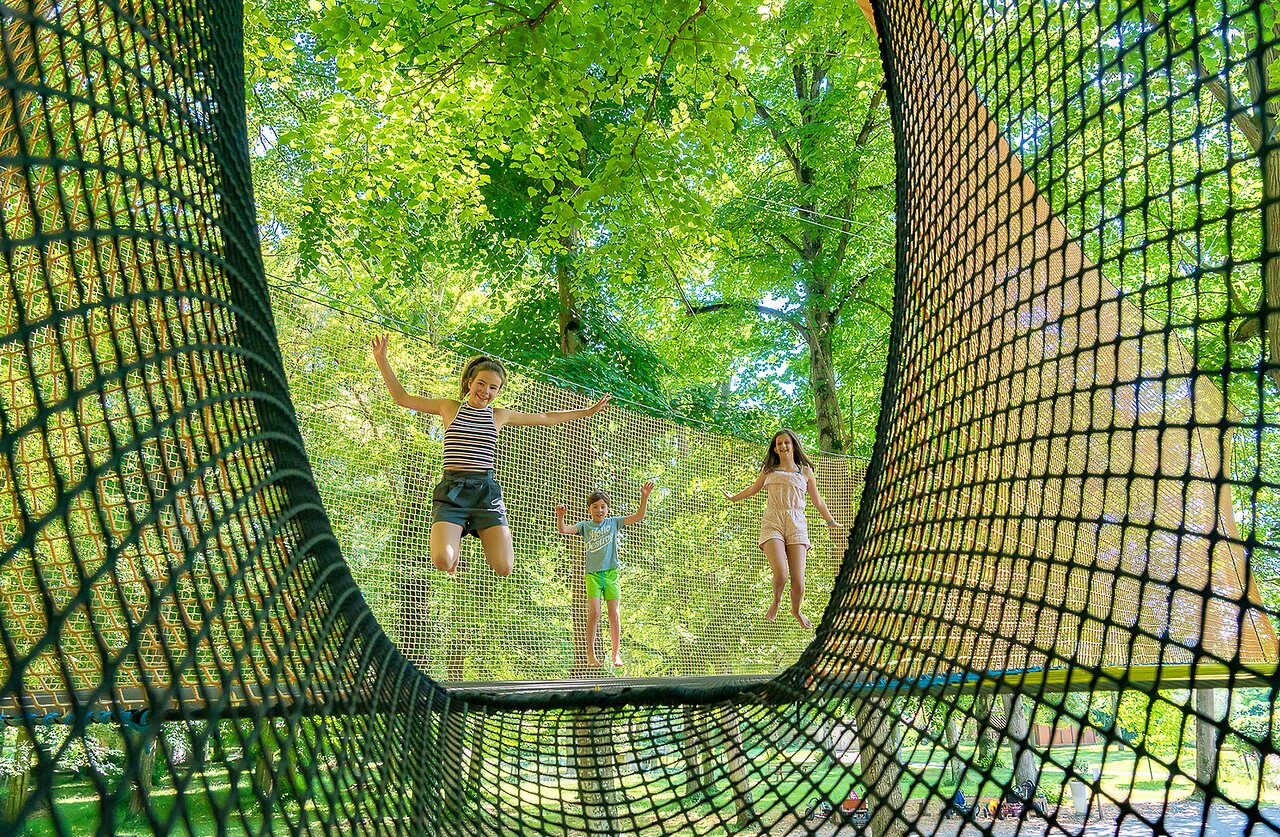 Enfants sautant sur un filet de jeux g�ant au camping CAPFUN Montsabert � COUTURES (49).